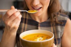 close-up of a woman having some soup