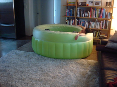 A woman relaxing in a mini pool inside the living room