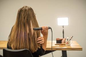 a woman straightening her hair