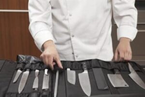 chef choosing blade sharpener from set