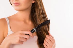 young woman combing hair