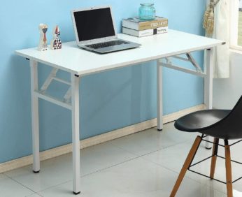 a white computer table with a laptop and books on top