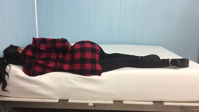 a-woman-wearing-a-plaid-jacket-sleeping-soundly-on-her-bed