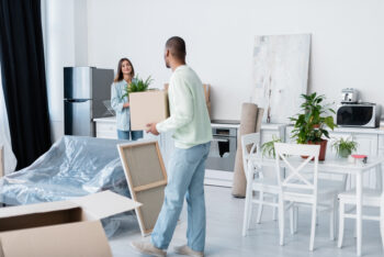 a couple is arranging furniture in their new home