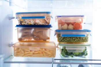 different foods inside the fridge in various clear boxes